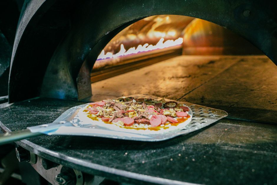 Plated pizza slice with fresh toppings and crispy crust