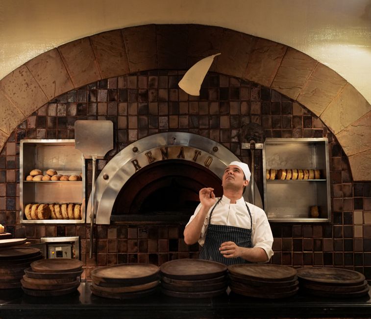 Traditional brick pizza oven interior with active flames